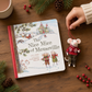 Mellow Monkey Mouseville storybook and felted mouse ornament featuring a festive winter scene on a wooden table.