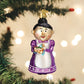 Mellow Monkey Cheery Mrs. Claus blown glass holiday ornament holding a festive cake. Purple dress with white apron.