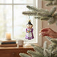 Mellow Monkey Cheery Mrs. Claus blown glass holiday ornament, 4.25-in, wearing a purple dress and white apron, holding cookies.