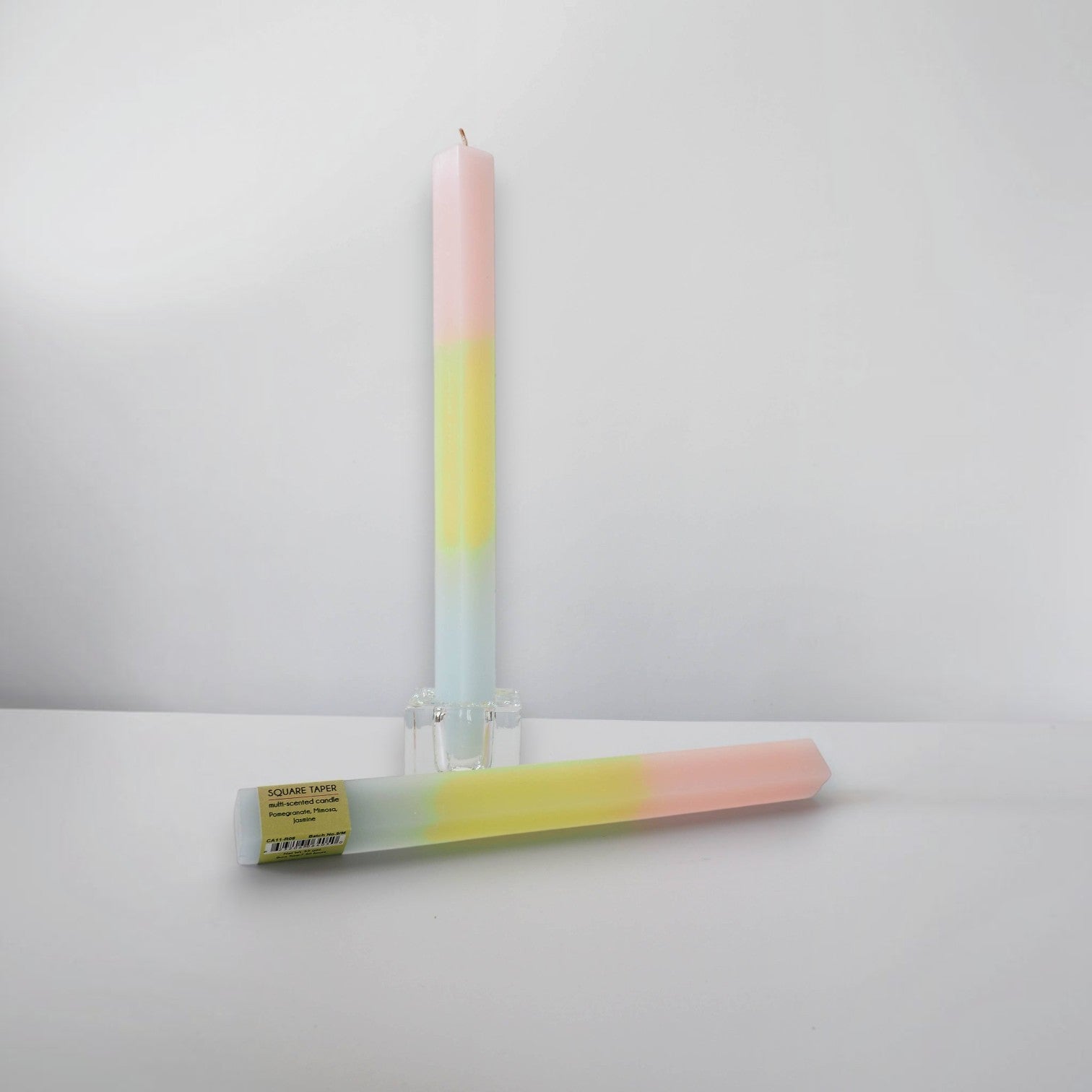 Mellow Monkey multi-scented square taper candle in pink, yellow, and blue ombre paraffin wax with a cotton wick.