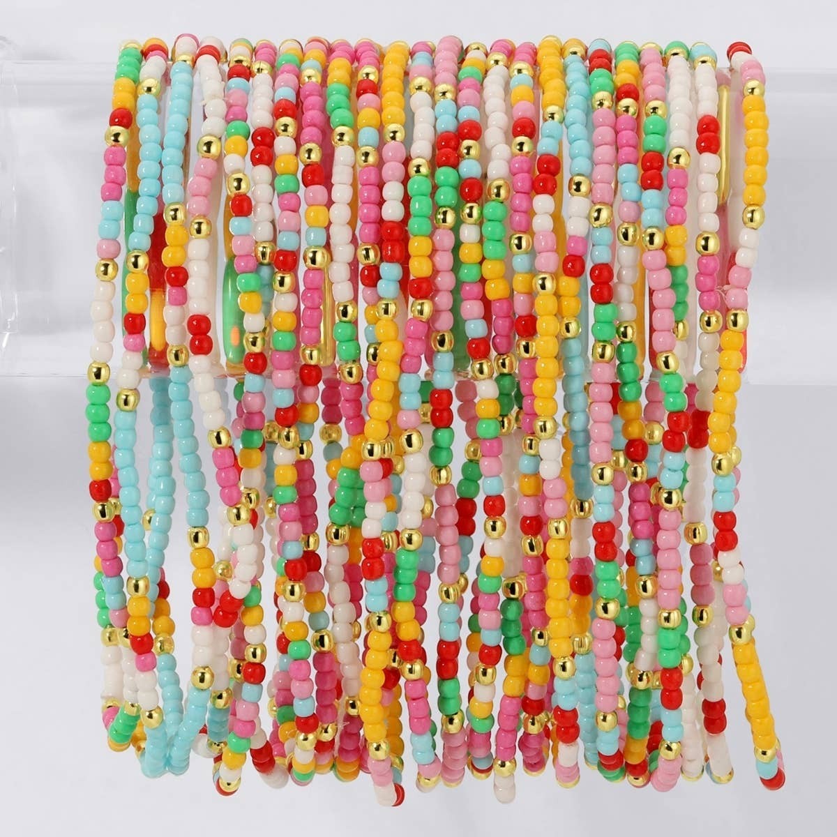 Mellow Monkey stretch seed bead bracelets in aqua, yellow, and red with 18k gold plated brass bead accents.