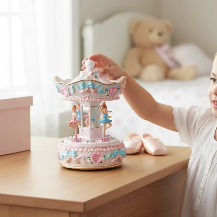 Mellow Monkey 6-inch musical ballerina carousel with pink and blue details on a wooden table in a child's bedroom.