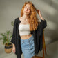 Mellow Monkey light green 4-layer muslin kimono robe with frayed hem and open front, worn by a model with curly red hair.