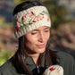 Mellow Monkey Naomi light natural wool headband with delicate floral embroidery worn by a woman outdoors