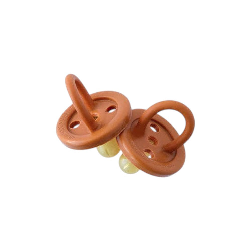 Mellow Monkey eco-friendly natural rubber pacifiers for babies aged 0-6 months with a seamless brown design.