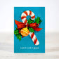 Mellow Monkey mini Christmas card featuring a candy cane, red bow, and holly with the text Lick it. Lick it good.
