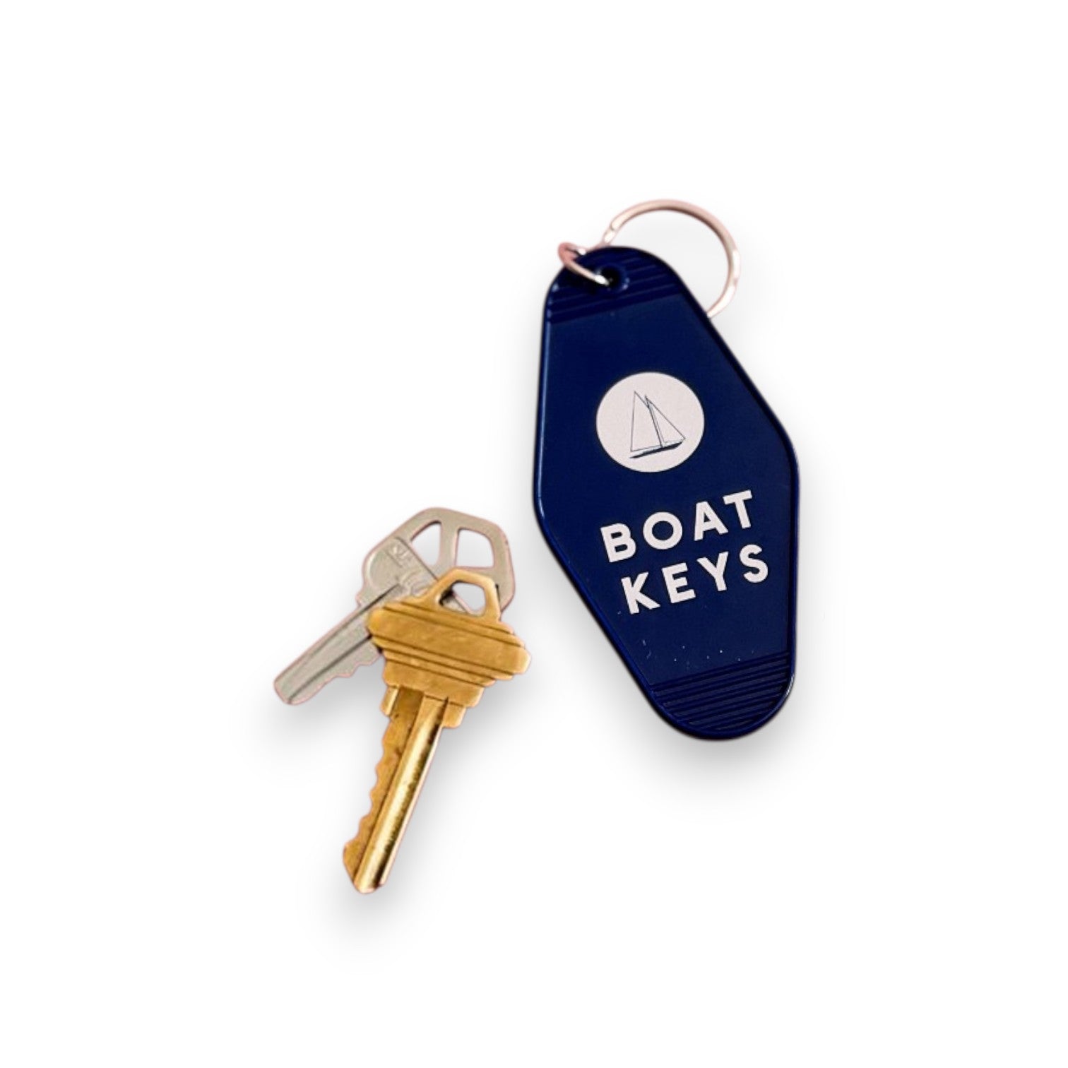 Mellow Monkey retro-style navy blue motel keychain with white sailboat icon and Boat Keys text attached to metal keys
