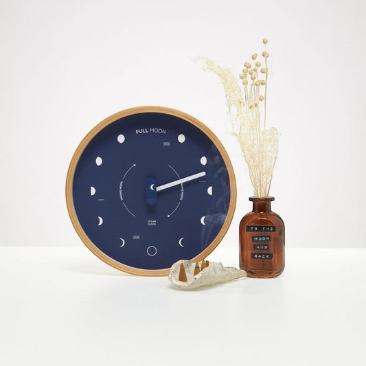 Mellow Monkey navy blue wood marine lunar phase clock with beech frame, white hand, and mineral glass face. Displays moon phases.