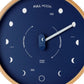 Mellow Monkey navy blue wood marine lunar phase clock with a natural beech frame, white hand, and mineral glass face. Shows moon phases.