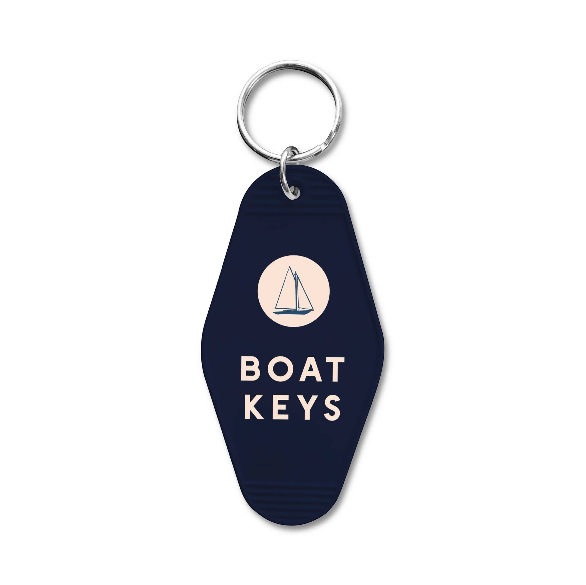 Mellow Monkey navy blue retro motel-style keychain with a sailboat icon and Boat Keys text for coastal decor.