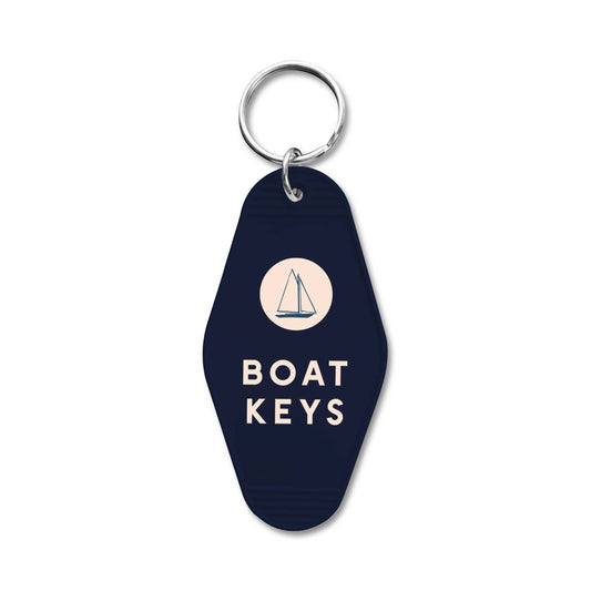 Mellow Monkey navy blue retro motel-style keychain with a sailboat icon and Boat Keys text for coastal decor.