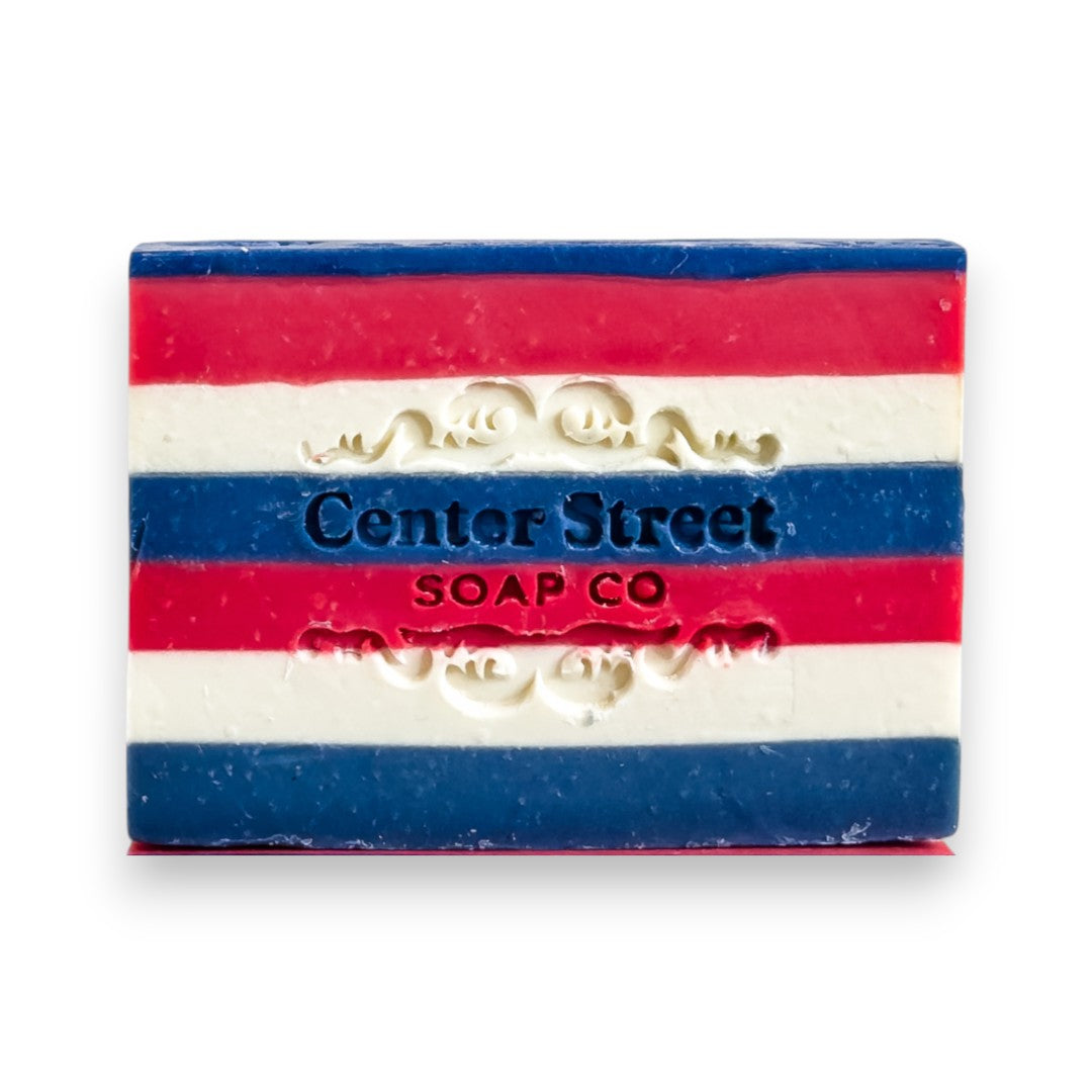 Mellow Monkey New Englander handmade soap bar with red, white, and blue stripes and a lobster cutout.