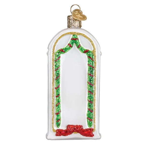 Mellow Monkey New Home Old World Christmas blown glass ornament with gold trim, green garland, and red bow.