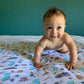 Mellow Monkey baby swaddle blanket featuring New Jersey themed illustrations on soft bamboo cotton muslin fabric.