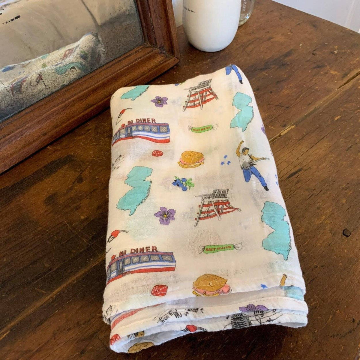 Mellow Monkey New Jersey themed muslin swaddle blanket in soft bamboo cotton with colorful state-inspired prints.