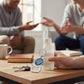 Mellow Monkey NBA New York Knicks metal bottle opener keychain held next to a glass bottle on a wooden table
