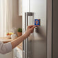 Mellow Monkey NBA New York Knicks logo magnet being placed on a stainless steel refrigerator door