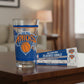 Mellow Monkey 16 oz clear glass pint glass featuring the blue and orange New York Knicks logo on a wooden table