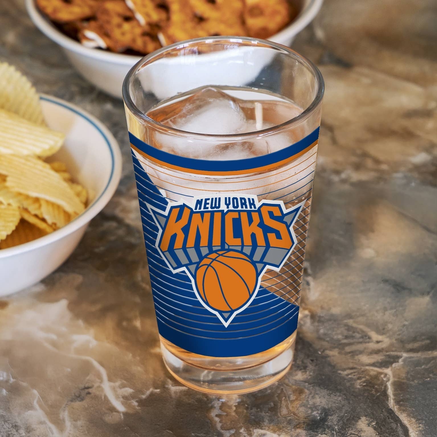 Mellow Monkey 16 oz clear glass pint cup featuring the blue and orange New York Knicks basketball team logo