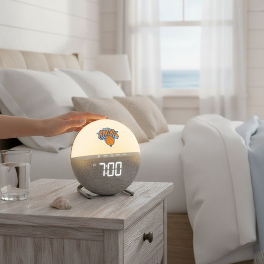 Mellow Monkey New York Knicks sunrise alarm clock with glowing light and digital display on a bedside table