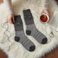 Mellow Monkey Nightfall Multi crew socks with black and white geometric textured patterns on a soft faux fur rug