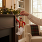 Mellow Monkey December Diamonds Nut Cracker merman ornament hanging on a fireplace mantel during the holidays