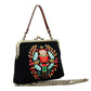 Mellow Monkey black cotton-linen kisslock bag featuring a festive embroidered Nutcracker and holly wreath design.