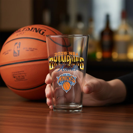 Mellow Monkey 16-oz clear glass pint featuring 2026 NBA Champions NY Knicks logo held in hand near a basketball.