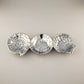 Mellow Monkey OCEAN Shell Triple Dip Tray in silver, shaped like a nautilus, sand dollar, and scallop shell. Made of aluminum.