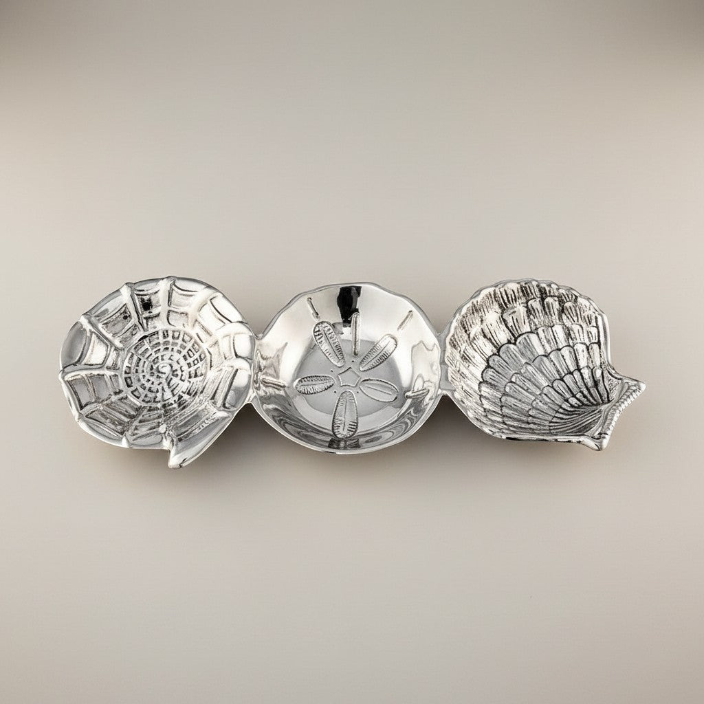 Mellow Monkey OCEAN Shell Triple Dip Tray in silver, shaped like a nautilus, sand dollar, and scallop shell. Made of aluminum.