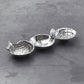 Mellow Monkey OCEAN Shell Triple Dip Tray in silver aluminum, shaped like nautilus, sand dollar, and scallop shells.