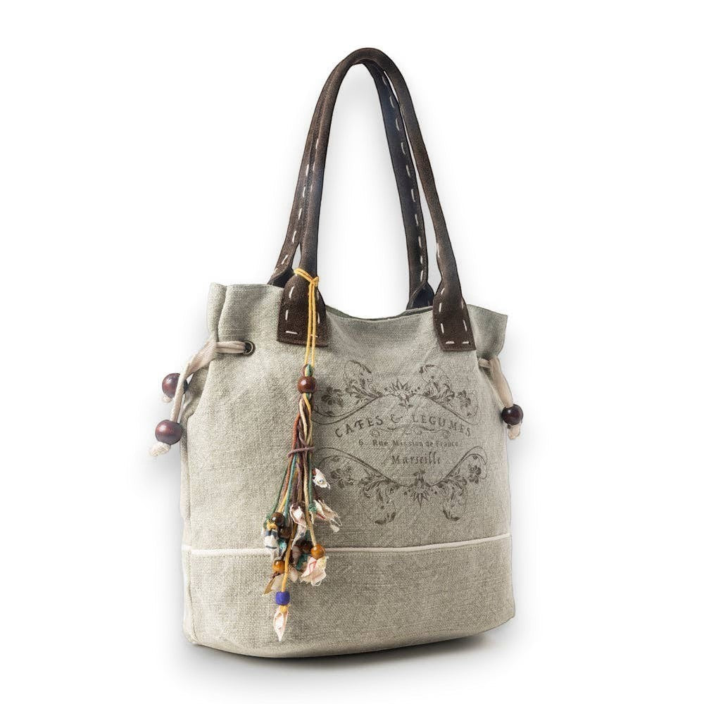 Mellow Monkey Old Soul tote bag in willow ash up-cycled canvas with vintage print, leather handles, and bead tassels.