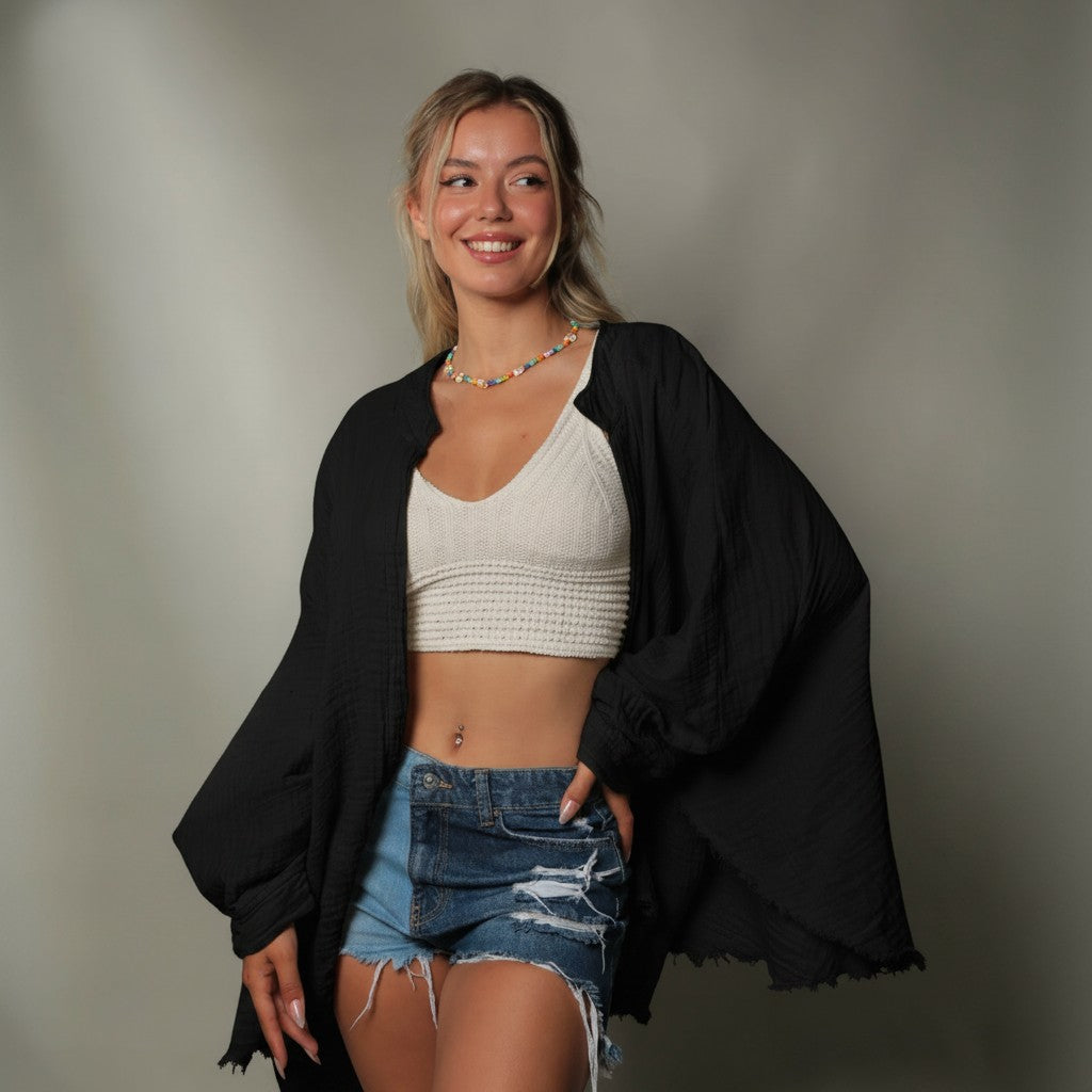 Mellow Monkey olive green 4-layer muslin kimono robe with wide sleeves and raw hem. Model wears with white crop top and denim shorts.
