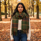 Mellow Monkey Kylie olive windowpane plaid fringe scarf worn by a woman in a park with autumn leaves