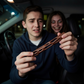 Mellow Monkey One Wish Willow novelty figure held by a man in a car with a spooky woman smiling in the background