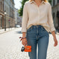 Mellow Monkey orange faux leather mini handbag keychain with gold hardware and colorful scarf detail.