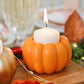 Mellow Monkey set of 6 orange resin pumpkin candle holders holding a white votive candle on a wooden table