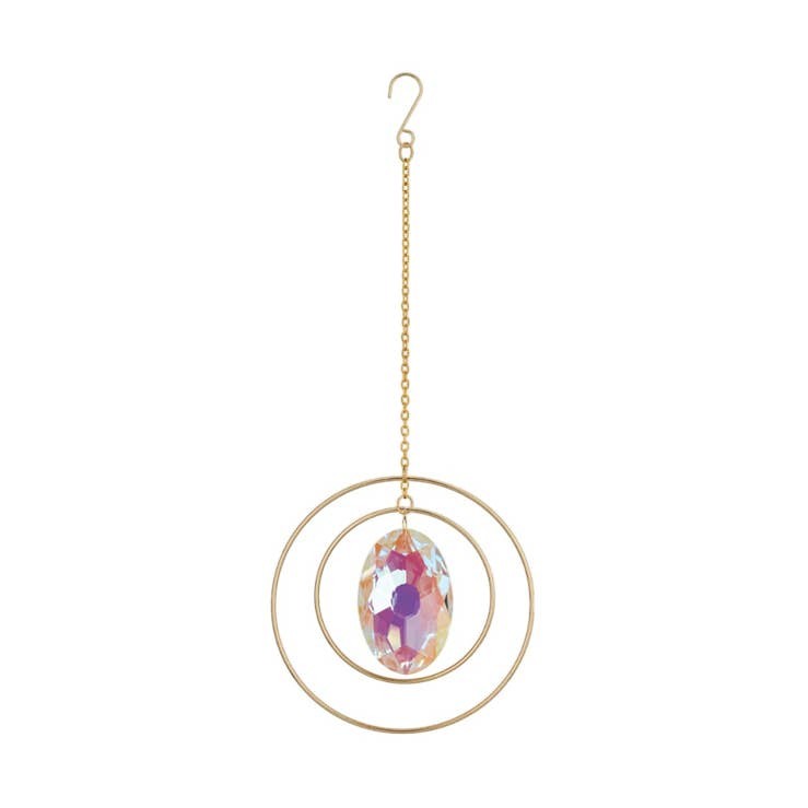 Mellow Monkey oval crystal suncatcher with iridescent stone and gold metallic rings hanging on a delicate chain