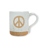 Mellow Monkey speckled stoneware mug featuring a hand-carved peace sign design on a cream-colored ceramic body.