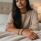Mellow Monkey bracelet set featuring freshwater baroque pearls and indigo crystals with a 14K gold-plated charm.
