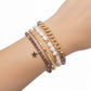 Mellow Monkey bracelet stack featuring baroque freshwater pearls, plum crystal beads, and a 14K gold-plated star charm.