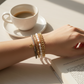 Mellow Monkey bracelet stack featuring baroque freshwater pearls, black diamond crystals, and a gold star charm.