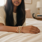 Mellow Monkey bracelet stack featuring freshwater baroque pearls, pink crystals, and a 14K gold-plated star charm.