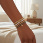 Mellow Monkey bracelet stack featuring freshwater baroque pearls, black diamond crystals, and a 14K gold star charm.