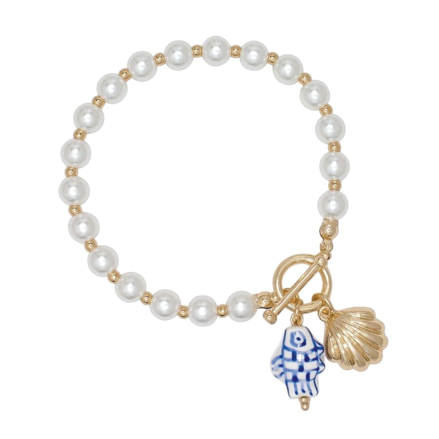 Mellow Monkey pearl bracelet featuring a hand-painted blue and white fish charm and a gold seashell pendant.