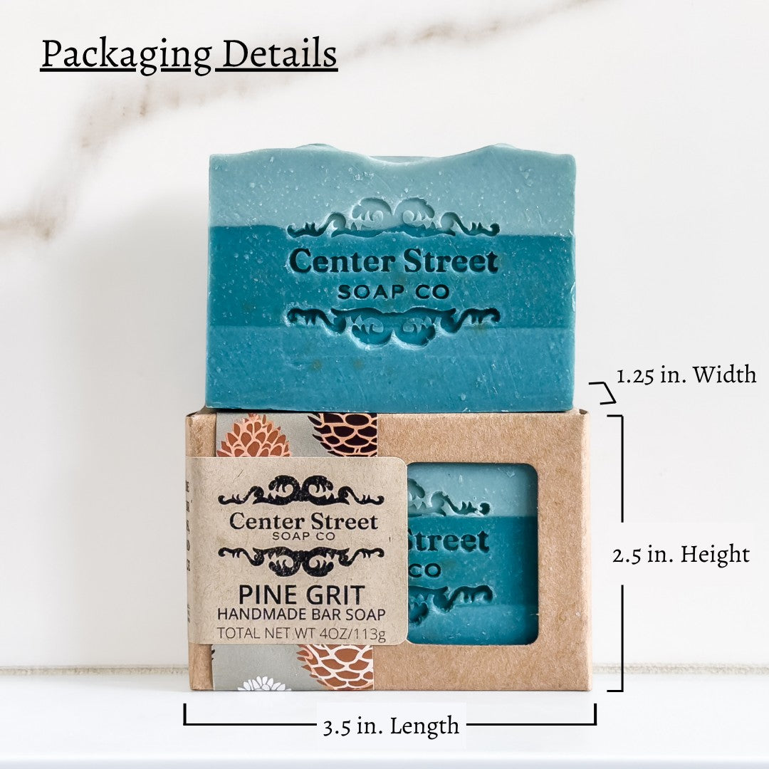 Mellow Monkey Pine Grit exfoliating handmade soap bar in a recyclable kraft box with a window showing blue soap.
