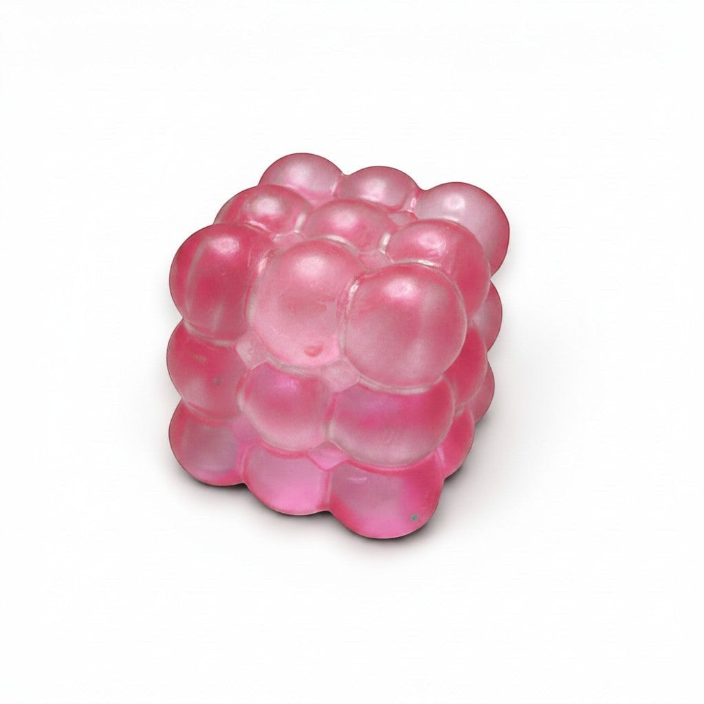 Mellow Monkey pink glittery bubble cube squeeze ball for stress relief and sensory fidget play.