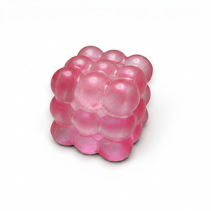 Mellow Monkey pink glittery bubble cube squeeze ball for stress relief and sensory fidget play.