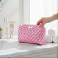 Mellow Monkey Garden Gate toiletry bag in pink and white diamond pattern on a marble bathroom counter