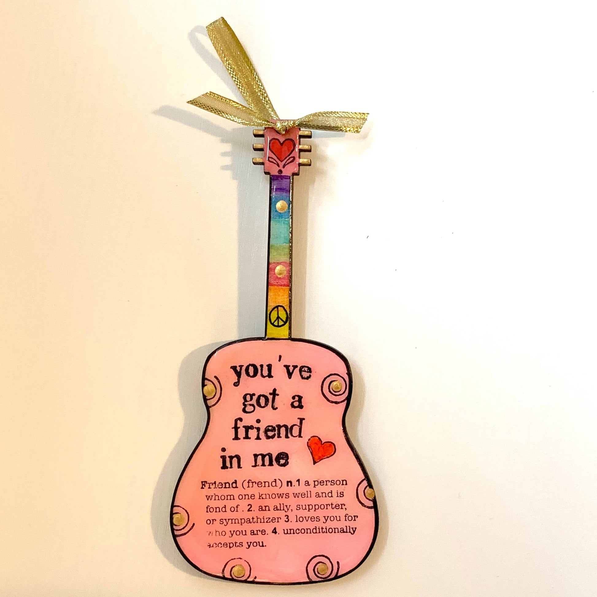 Mellow Monkey pink hand-painted guitar ornament with You've Got A Friend in Me text and gold ribbon hanger.